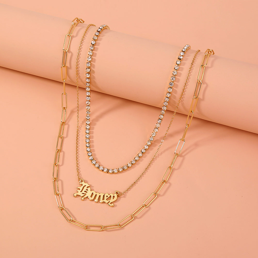 layered “Money” pendant necklace.