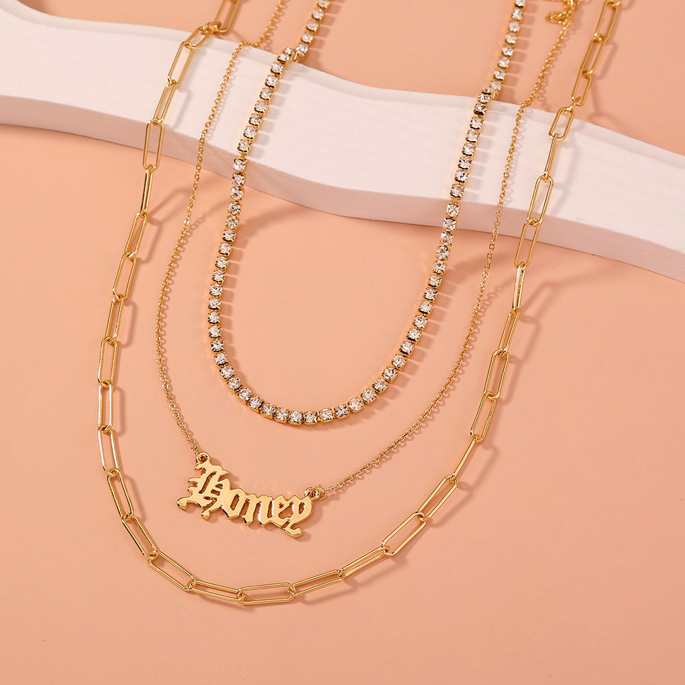 layered “Money” pendant necklace.