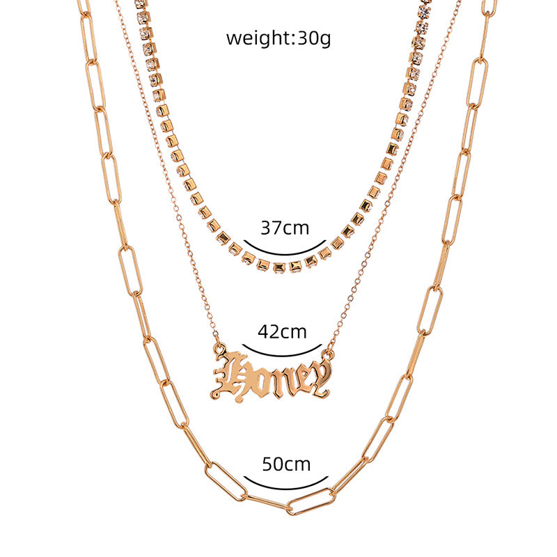 layered “Money” pendant necklace.