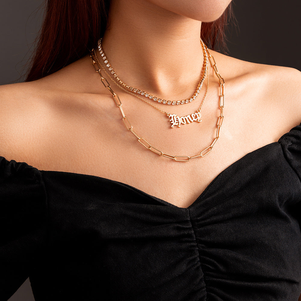 layered “Money” pendant necklace.