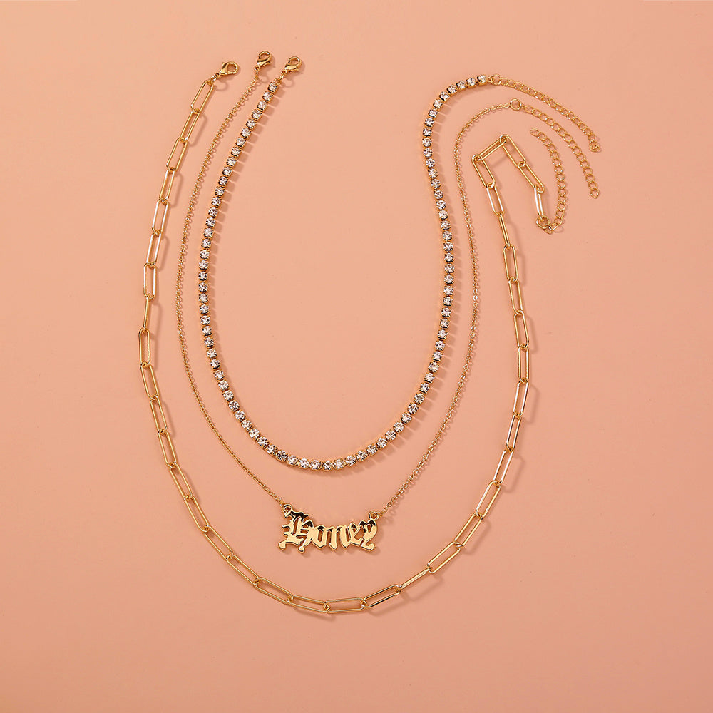 layered “Money” pendant necklace.